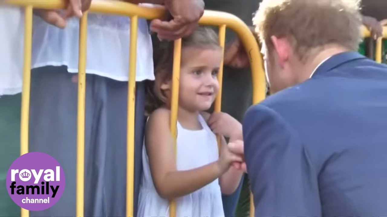 Little girl offers Prince Harry her drawing in Saint Kitts and Nevis