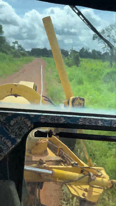 Grass cutting machinery to widen new roads #road #grader