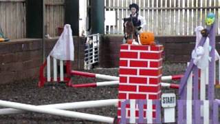 Lizzie riding the 1' at The Stables, Wilstead. Details