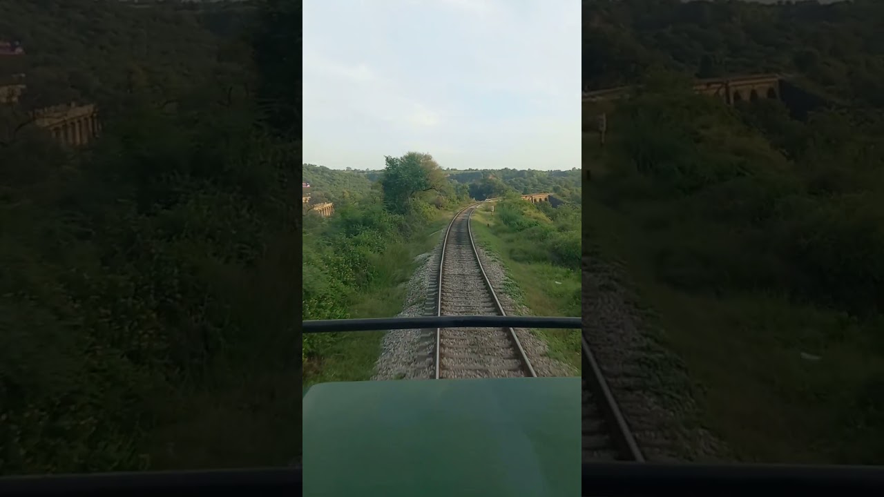 Live train passing over 9 arch bridge near Bakrala station in mountains countryside  