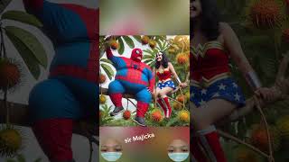 Spiderman And Wonder Woman Climbing A Rambutan Tree