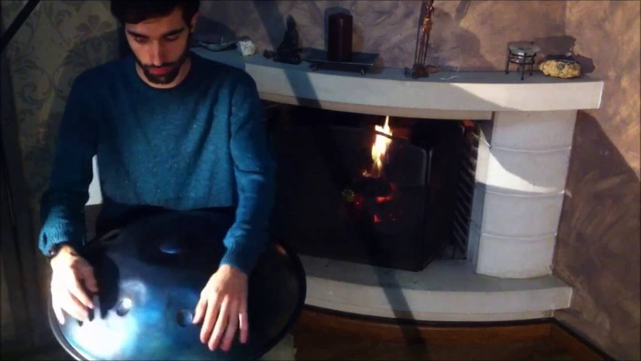 Alma Handpan playing by the fireplace