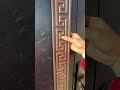This is a high-end, sturdy front door with a black and gold color scheme. #doors #metal