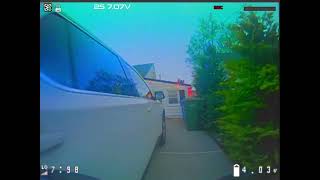 A tiny drone plays in the yard