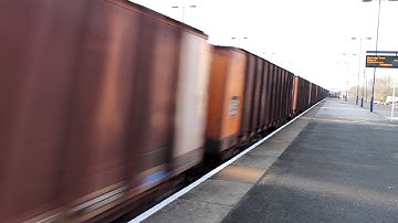 DB class 66046 passes with a rake of BSSC iron ore wagons