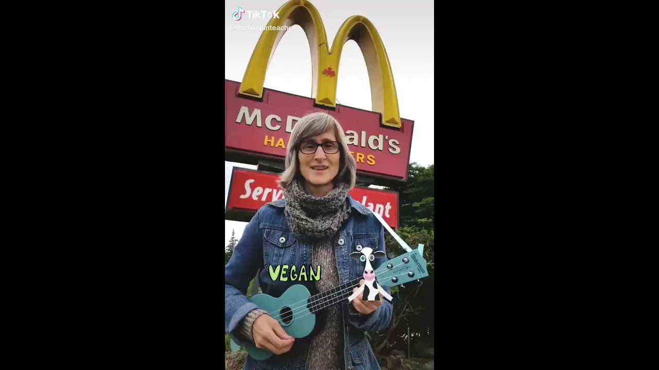 Miss Karen sings a vegan song in front of McDonalds