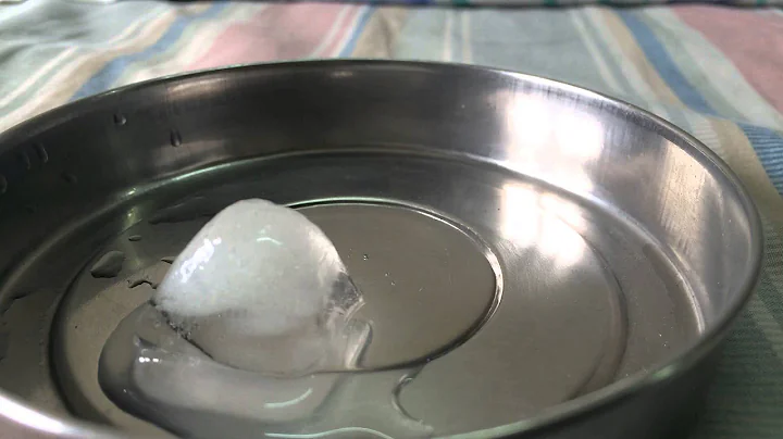 Ice cube melting at room temperature.