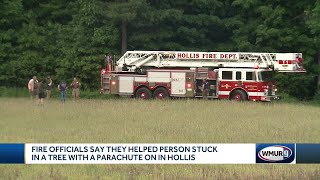 Fire officials help person stuck in tree with parachute on in Hollis