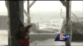 Waves crash over seawall in Scituate