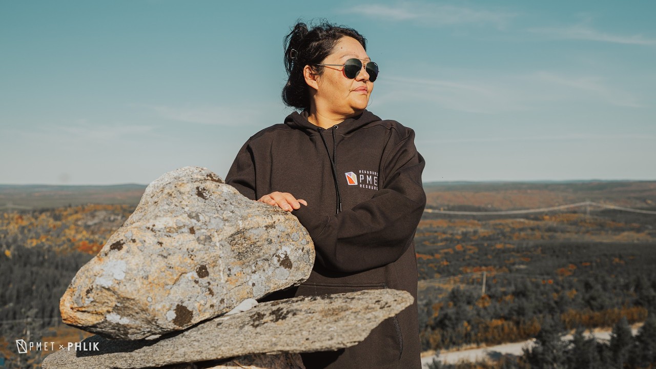 Charlene Gilpin beside an inukshuk above the camp