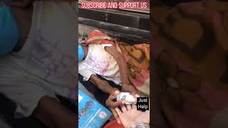 Helping a homeless street person sleeping near road