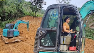 The Girl and the Driver Mini excavator operation leveling the ground.