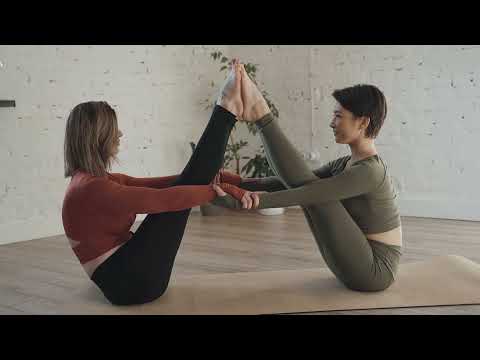 Two women doing Yoga - two women performing yoga exercises on the floor |  yoga for beginners