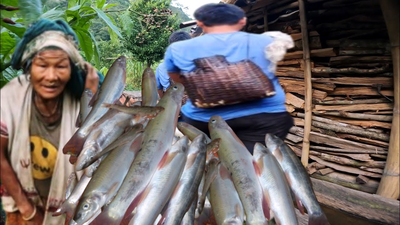 Happy family organic fish cooking recipe in the mid-eastern rural Region of Nepal