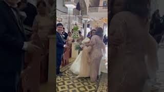 Bride walks down flooded aisle after Typhoon in the Philippines