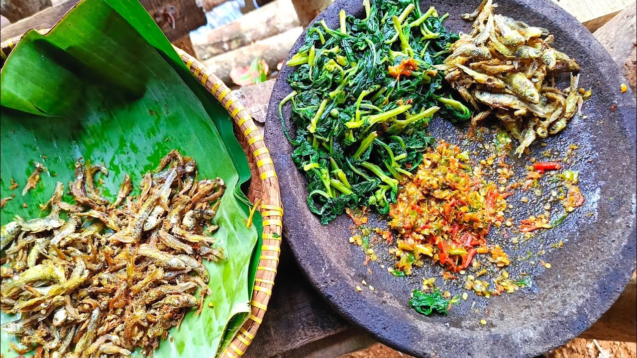 This man makes healthy food, cooking organic vegetables and crispy fried baby fish
