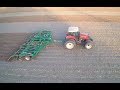 Versatile 305 tractor pulling a great plains turbo max