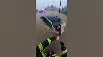 Firefighter Saves Stranded Victim in Raging Flood