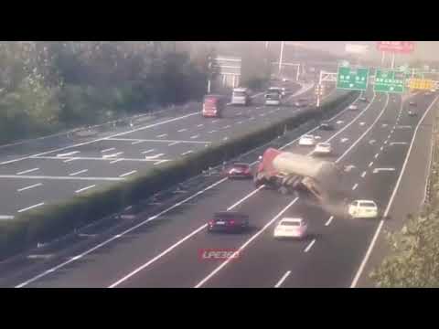 Tank truck flips over on freeway - YouTube