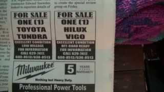Reading the Kaieteur News paper Guyana