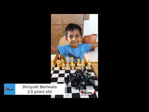 2.5 years old Shriyukt Beriwala arranges chess pieces on a board