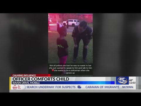 Caught on camera: officer comforts child at shooting scene
