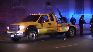 Stray bullet barely misses sleeping couple after 2 shot in tow truck