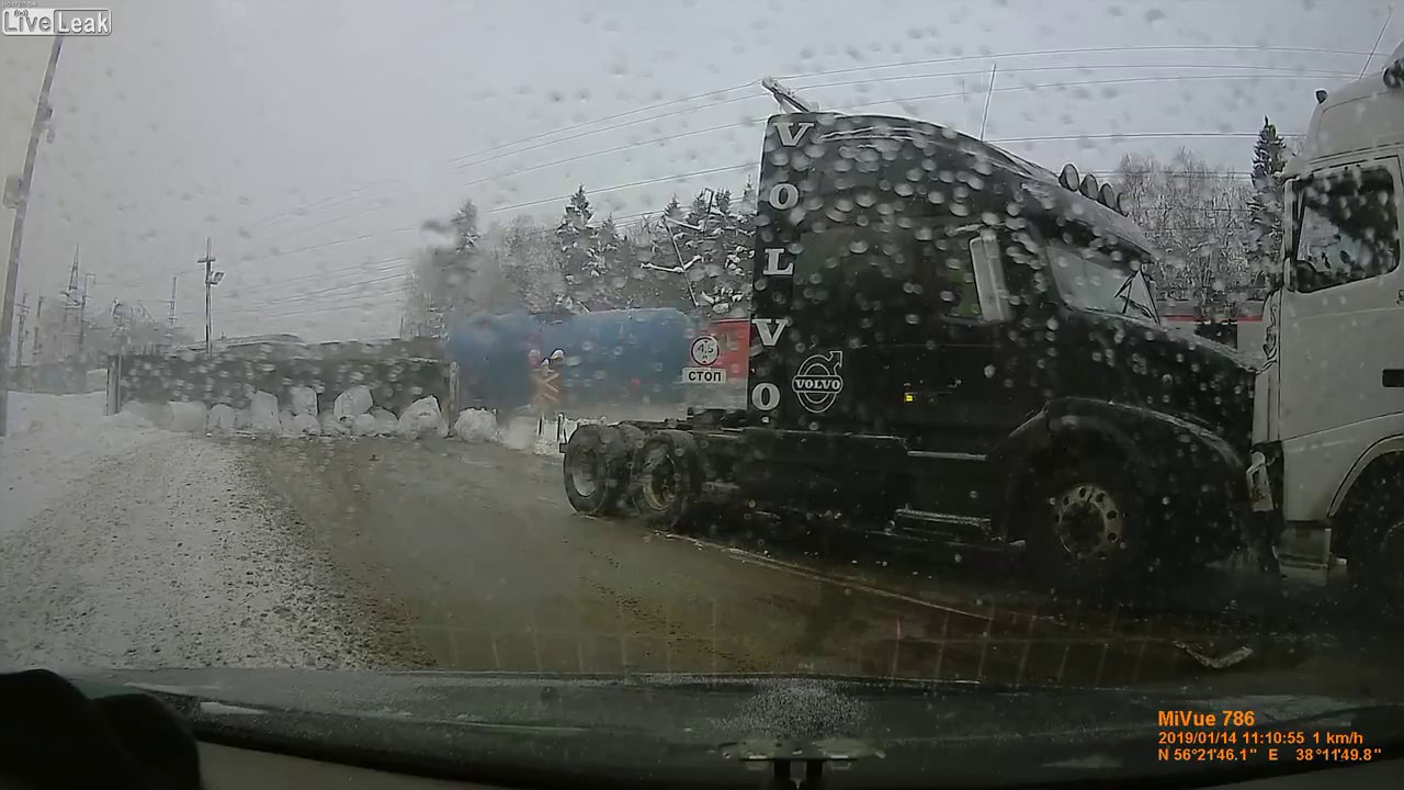 Train pushes a stuck truck off the tracks - YouTube