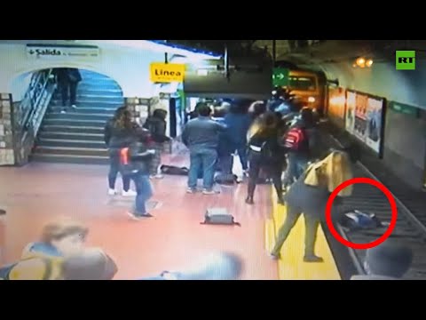 Fainted man knocks woman onto tracks in front of oncoming train