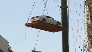 Crews begin removing vehicles from parking garage at Dallas apartments where crane collapsed
