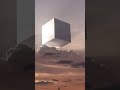 Our reality just got stranger. A majestic, glowing cube, partially veiled by clouds. Is it a glitch
