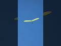 Yellow Hang Glider high in the sky Torrey Pines Gliderport San Diego California