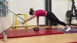 Front plank in push up position with unilateral band pull