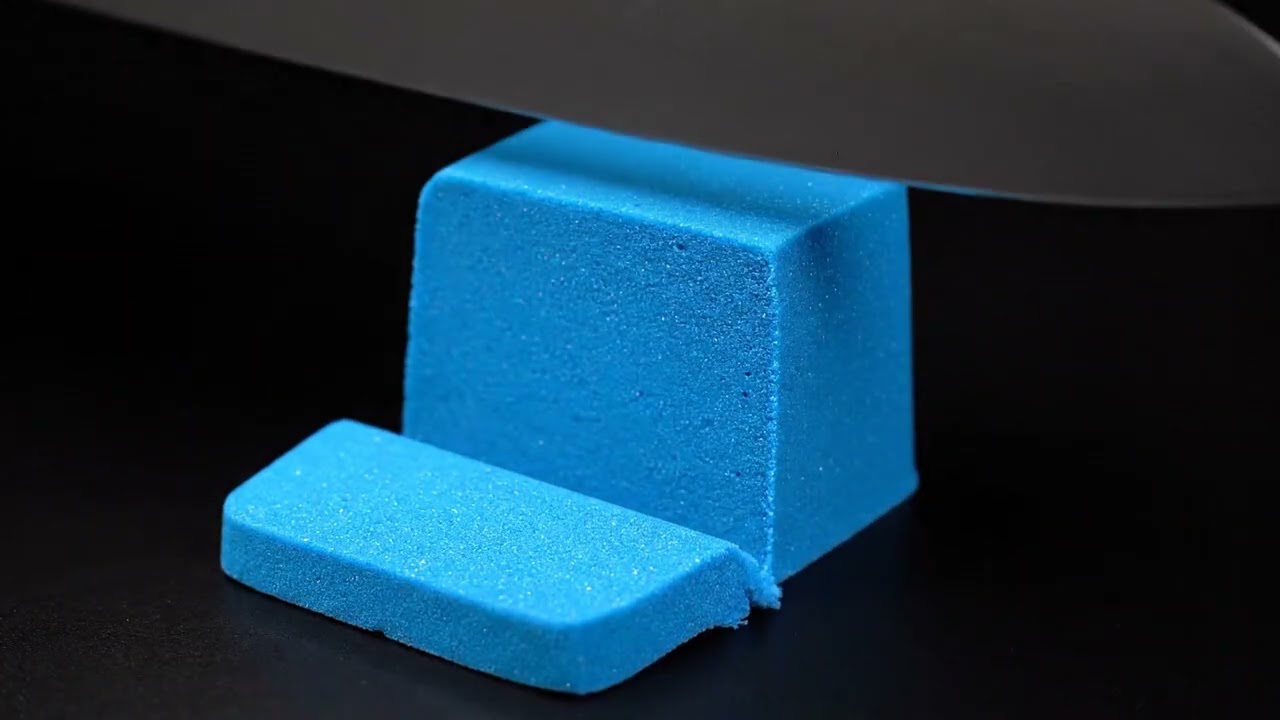 AI ASMR : A vibrant blue kinetic sand shape being cut