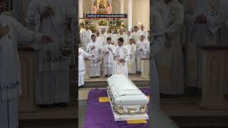 Father Picx Picardal blessed by fellow priests before burial