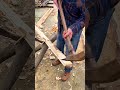Carving and shaping a long piece of timber log surface using a traditional heavy duty wooden adze