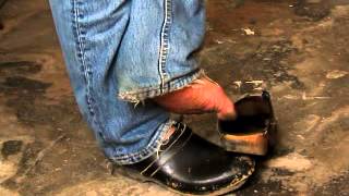 Barefoot In Well-Worn Clogs In The Workshop