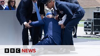 US President Biden trips and falls over at graduation event – BBC News