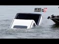 Car slides  sinks into a lake on live television leaves reporter shocked