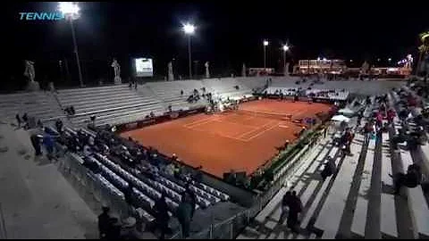 Tennis umpire Gianluca Moscarella scares away bird