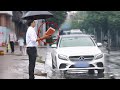 Man stands on the roadside with a brick in hand on a rainy day  social experiment