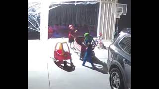 Boy dressed as Luigi gets pushed in red cart/wagon then falls off and faceplants (Security camera)