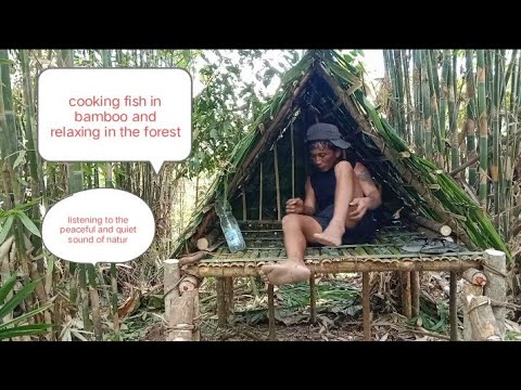 Cooking fish in the forest using bamboo near a hut in a bambo forest