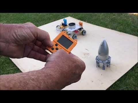 MakeCode Arcade drives Twin Mecanum Transporters Starship Fantasy Factory; Meowbit controller.