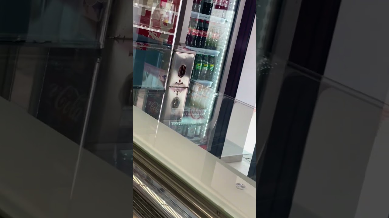 Boy rides Rolling Walker down sidewalk in front of store and falls on him back