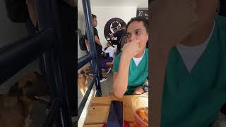 Hungry Dog Nudges Young Man With Nose Asking for Food