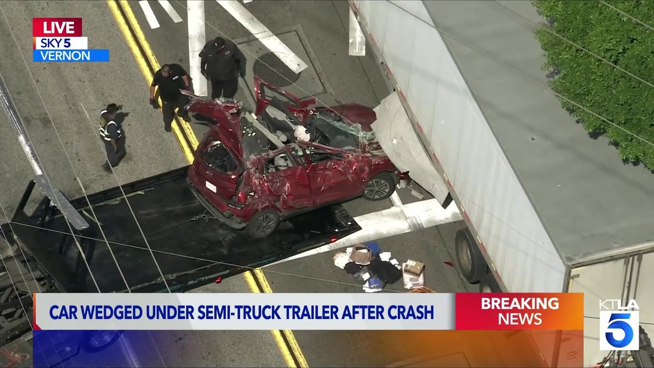 Car wedged under semi-truck trailer after crash in Vernon