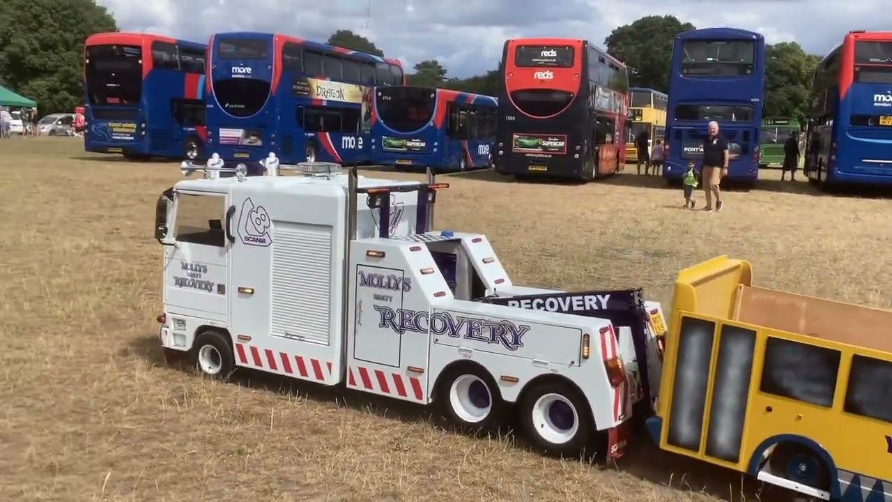 A cool mini bus tow truck driving along the bus rally!