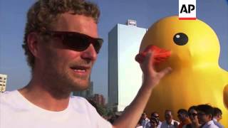 Thousands welcome giant inflatable rubber duck to port city