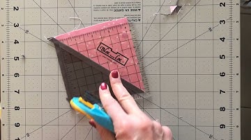 Trimming a Half Square Triangle with a Bloc Loc ruler